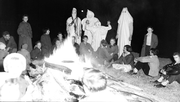 Gathering of ghost hunters infront of a bonfire.