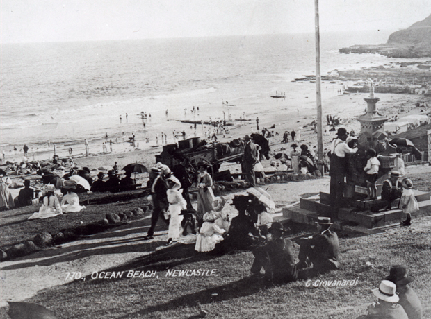 Newcastle beach with queue for drinks at water fountain